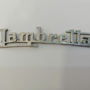 Emblema Lambretta metal pulido .